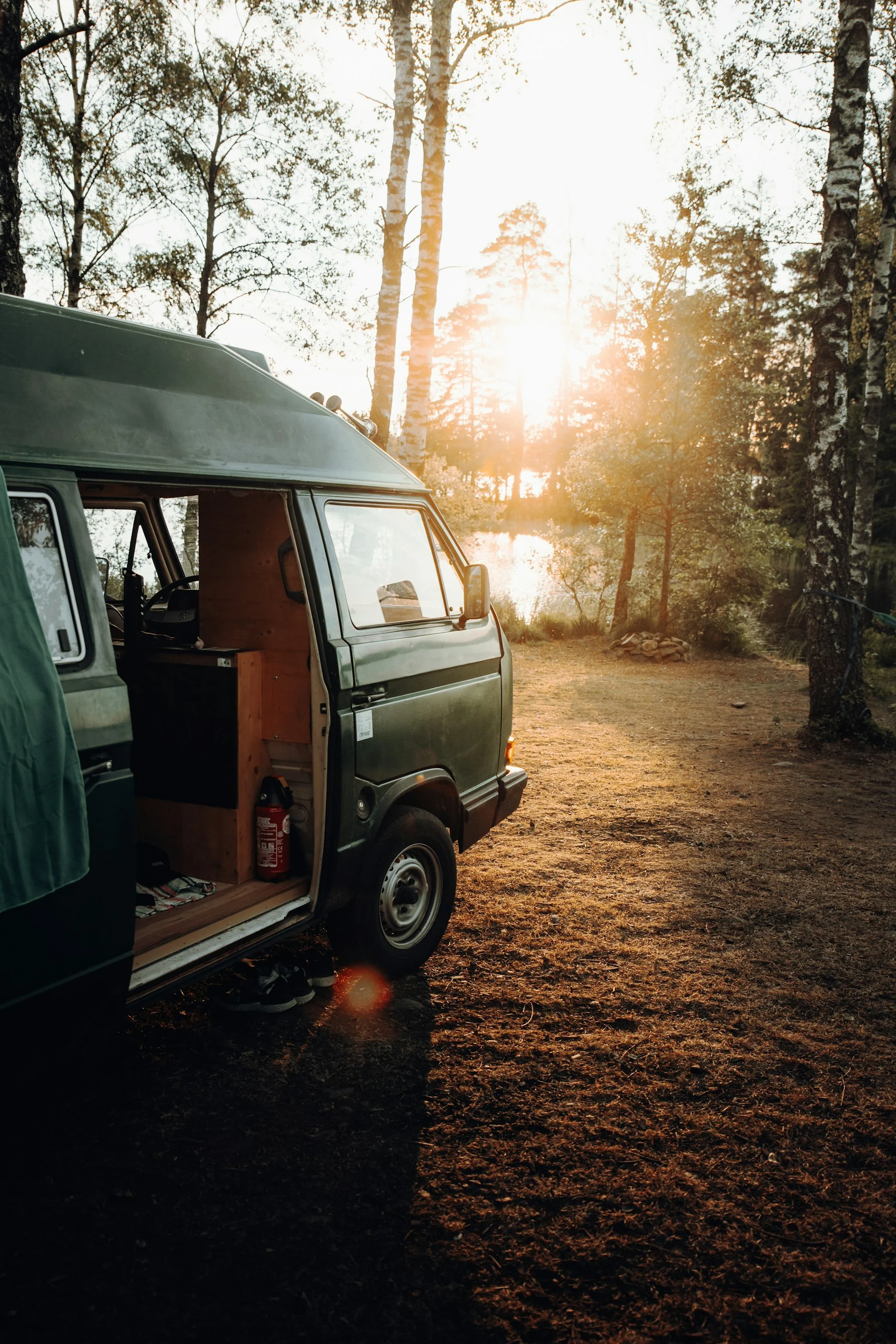 Camper van parked lakeside at golden hour