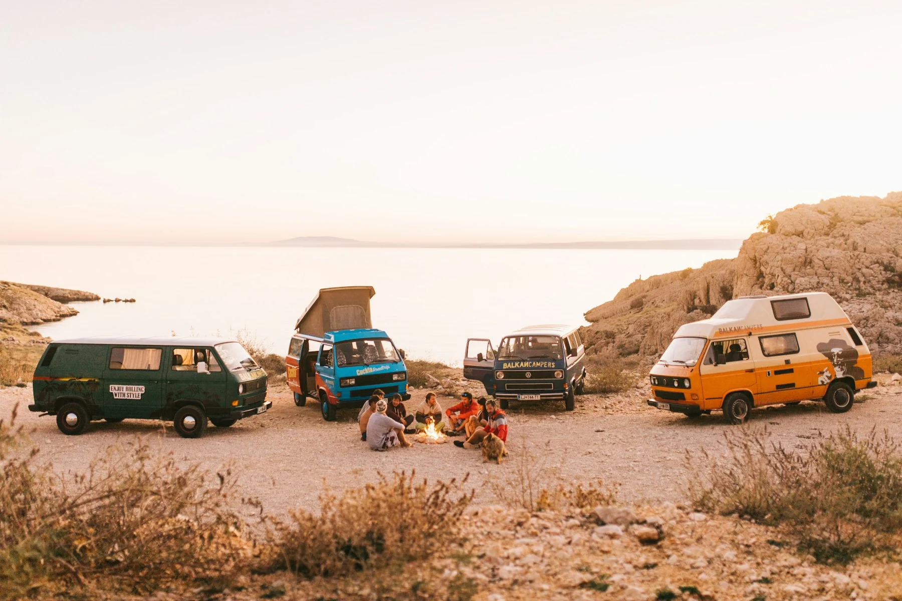 Camper vans parked at a coastal overlook campsite